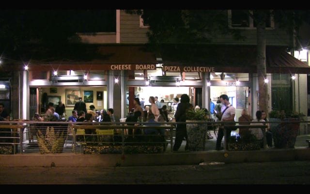 a group of people sitting outside a restaurant