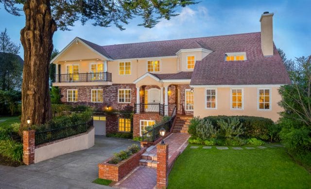 a large house with a brick driveway