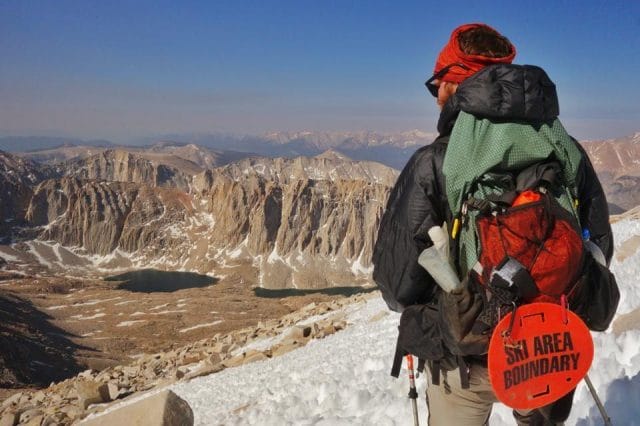 a person with a backpack on a mountain