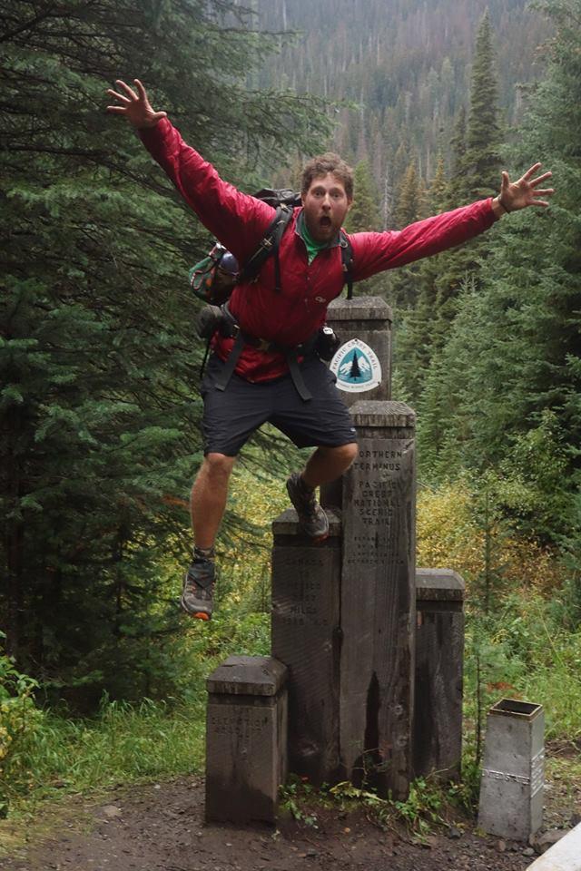 a man jumping off a stump