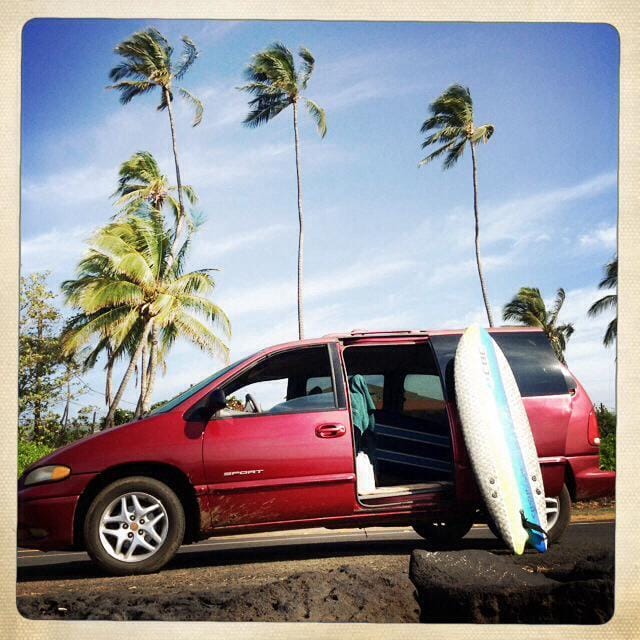 a car with a surfboard on the back