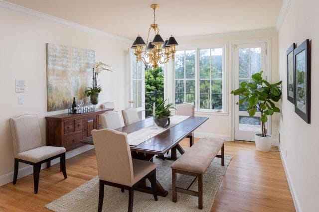 a dining room with a chandelier and chairs