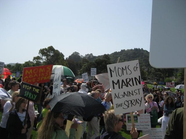 a crowd of people holding signs
