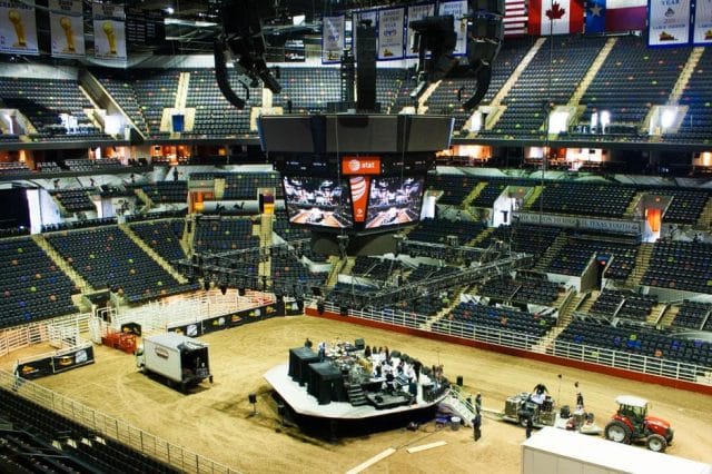 a large room with a large group of people and a large group of military vehicles