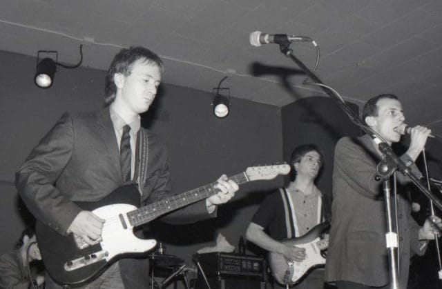 a group of men playing guitars