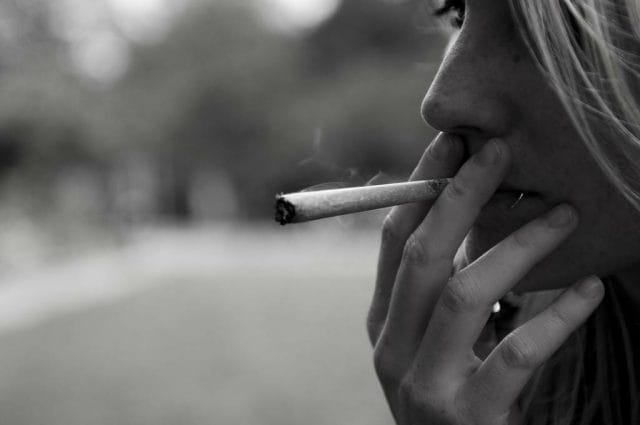 a person smoking a cigarette