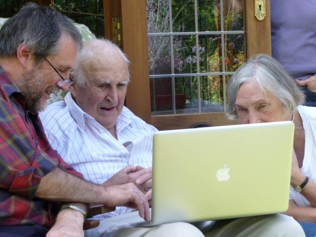 a man and a woman looking at a laptop