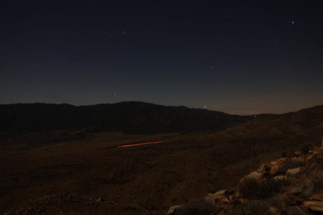 a landscape with a mountain in the background