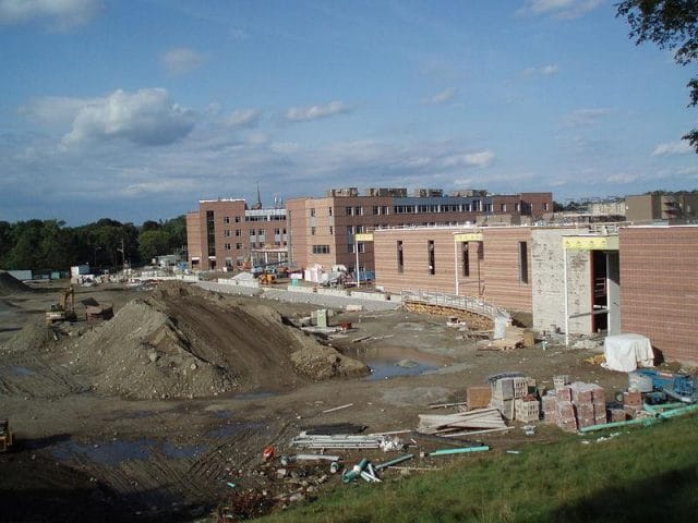 a construction site with a pile of dirt and buildings