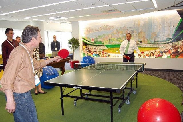 a group of people playing ping pong