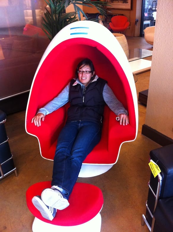 a woman sitting in a red chair