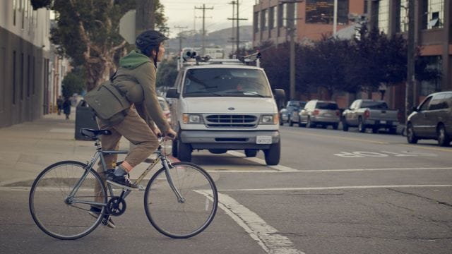 a person riding a bicycle on a street