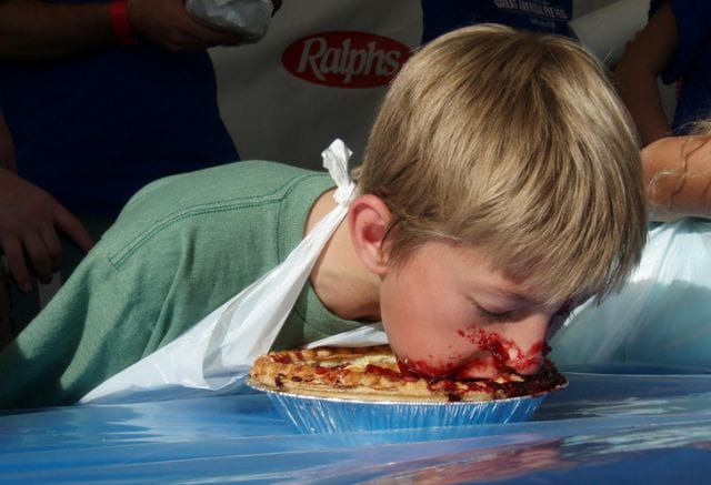 a boy eating a pizza
