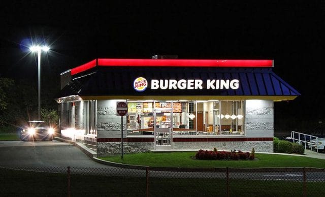 a restaurant with a car parked outside