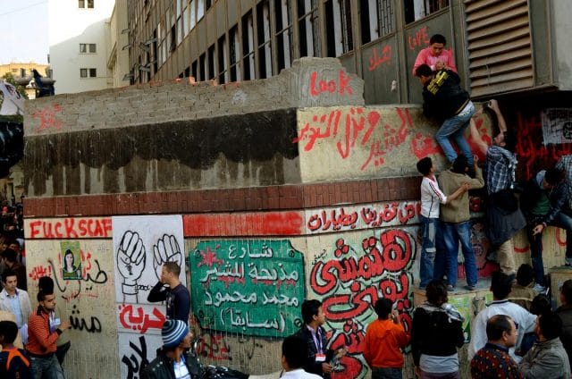 a group of people on a wall