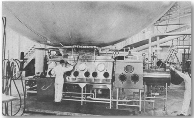 a group of men working on a machine