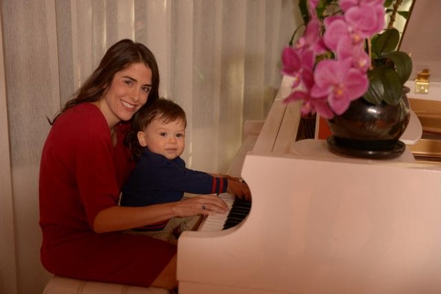 Erica Brescia and a child playing a piano