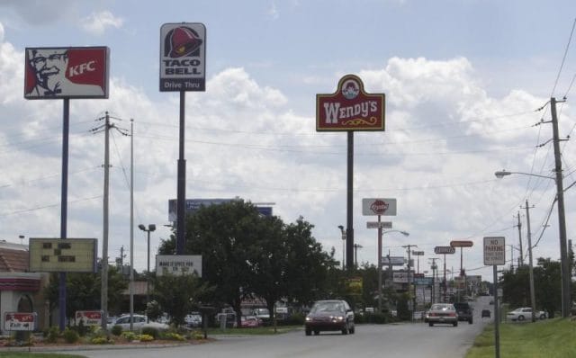 a street with signs and cars