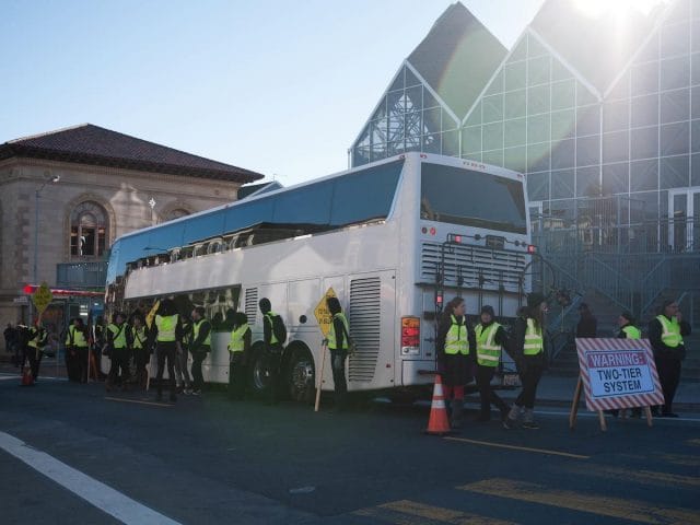 a group of people standing next to a truck