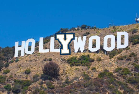 a sign on a hill with Hollywood Sign in the background