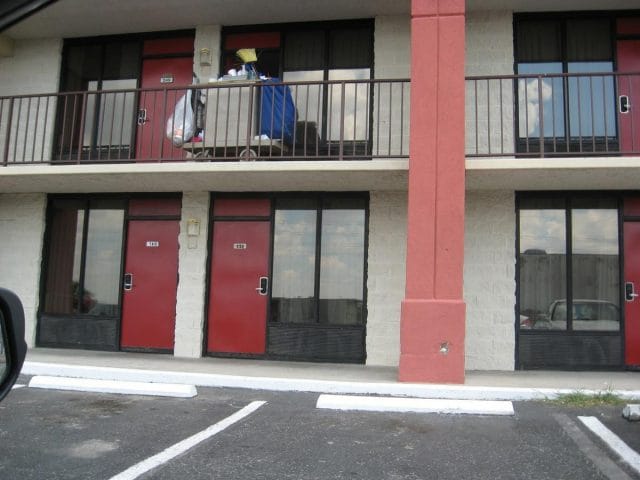 a building with a few people on the balcony