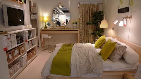 a bedroom with a mirror and a bed