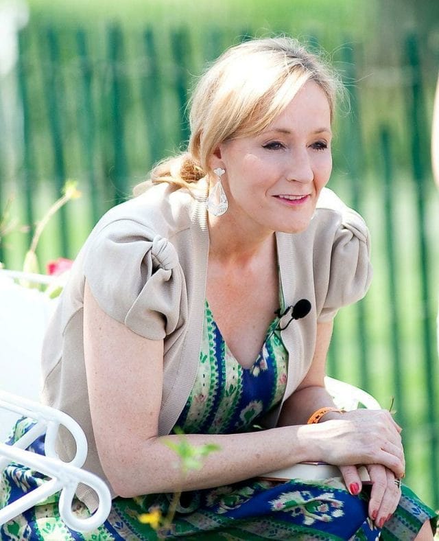 J. K. Rowling sitting on a blanket