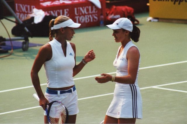 women holding tennis rackets