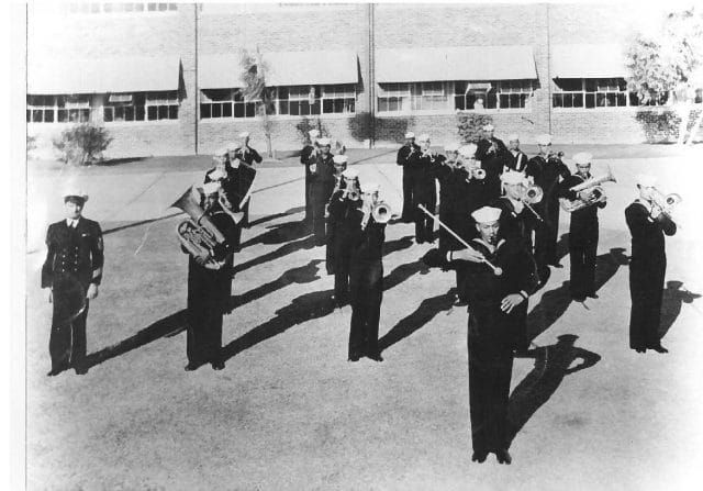 a group of men in military uniforms marching in a parade