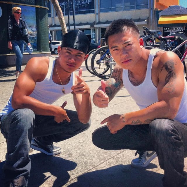 two men sitting on the ground