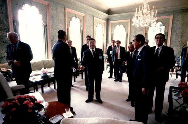 a group of men in suits in a room