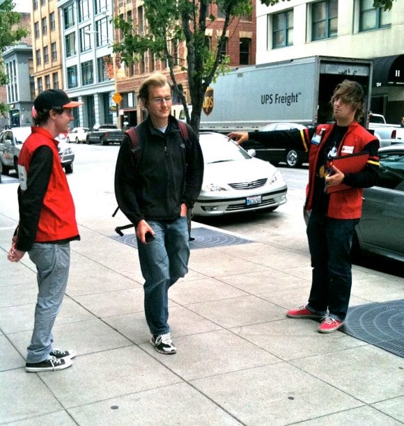 a group of men walking on a sidewalk