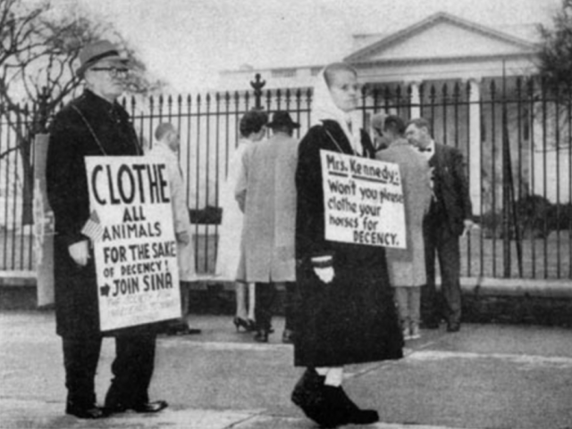 a group of people holding signs