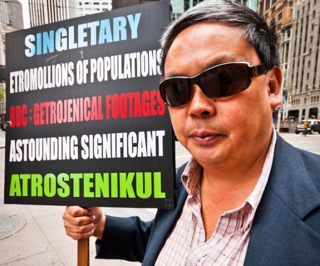 Frank Chu holding a sign
