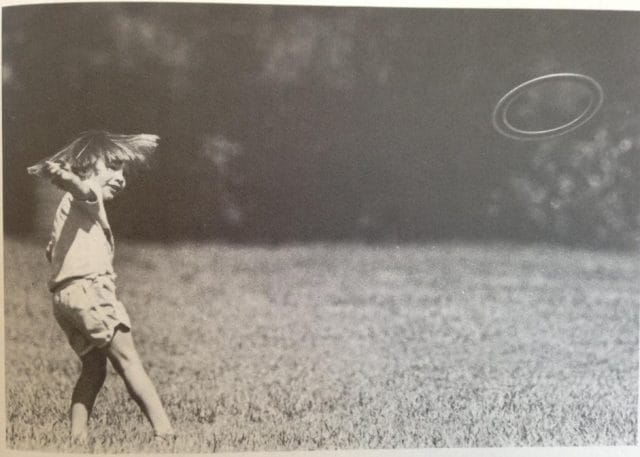 a girl throwing a frisbee