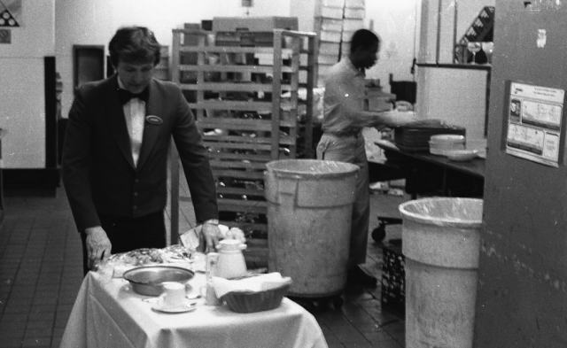 a man and woman cooking in a kitchen