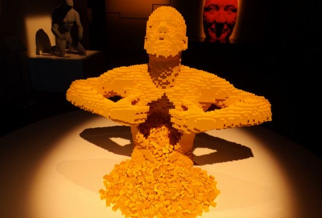 a sculpture of a person with a light saber