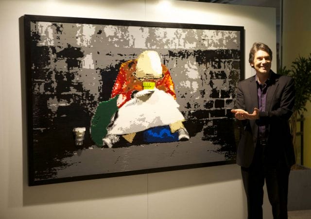 Dirk Denoyelle standing next to a painting