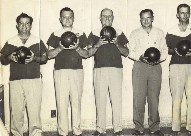 a group of people holding helmets