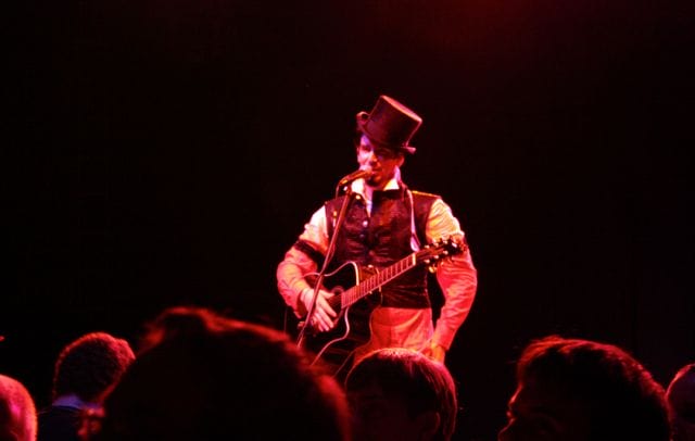 a man playing a guitar on a stage