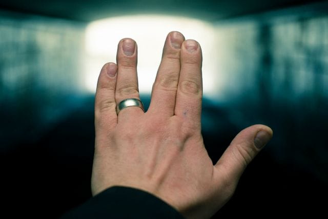 a person's hand with a ring on it