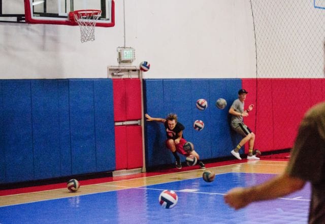a group of people playing volleyball