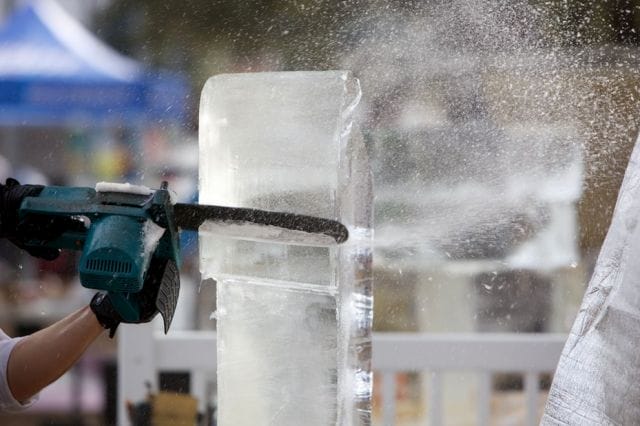 a person pouring liquid into a container