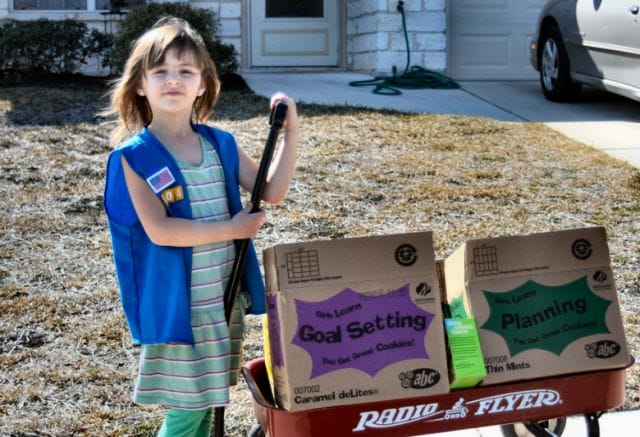 a girl holding a shovel and a box of pizza