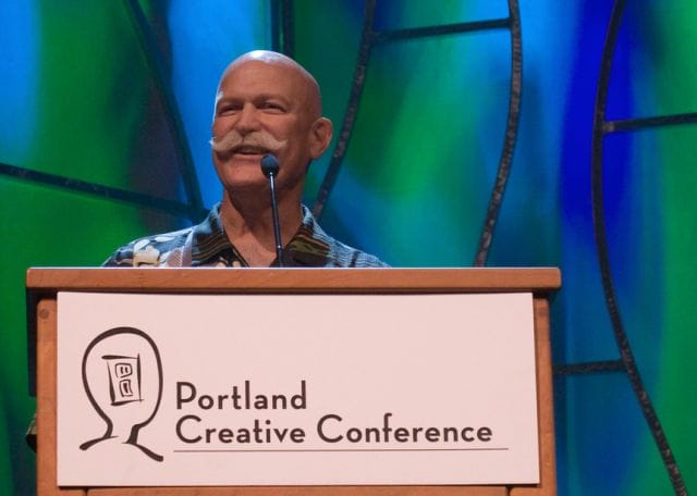 Will Vinton speaking into a microphone