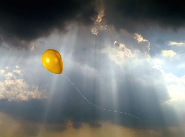 a yellow balloon in the sky