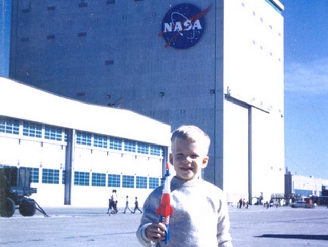 a boy holding a red object
