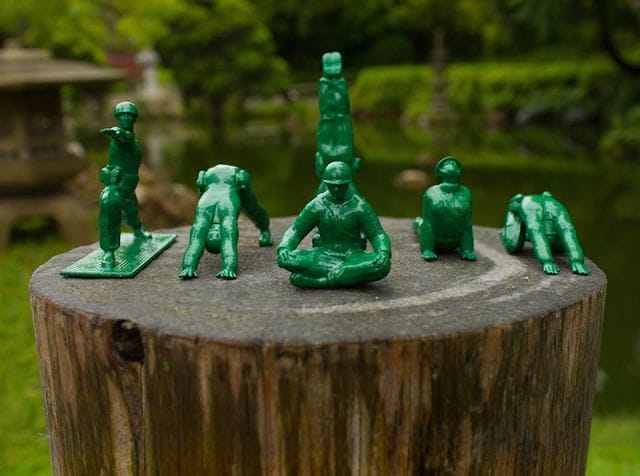 a group of green statues on a rock