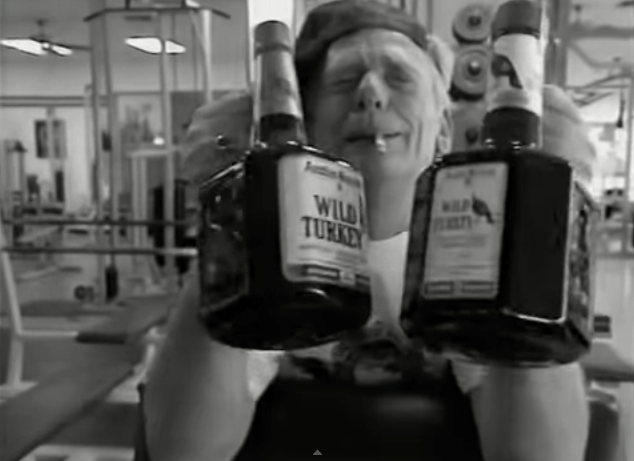 a person holding bottles of alcohol