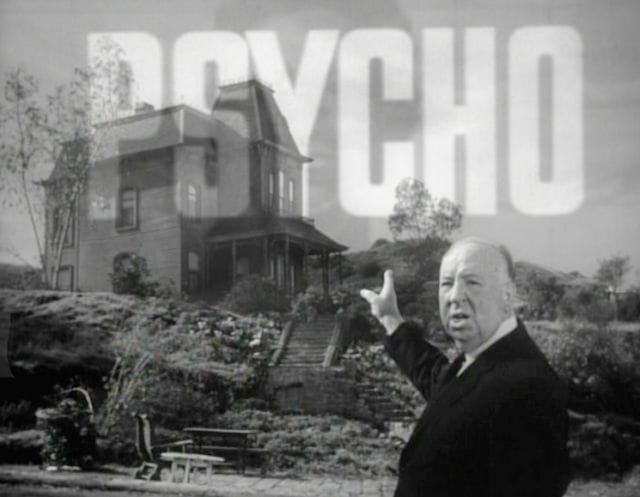 Alfred Hitchcock pointing at a house